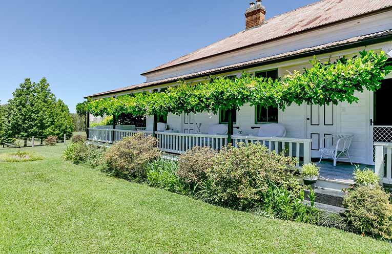 The timeless five-bedroom homestead, framed by established gardens and mountain views.