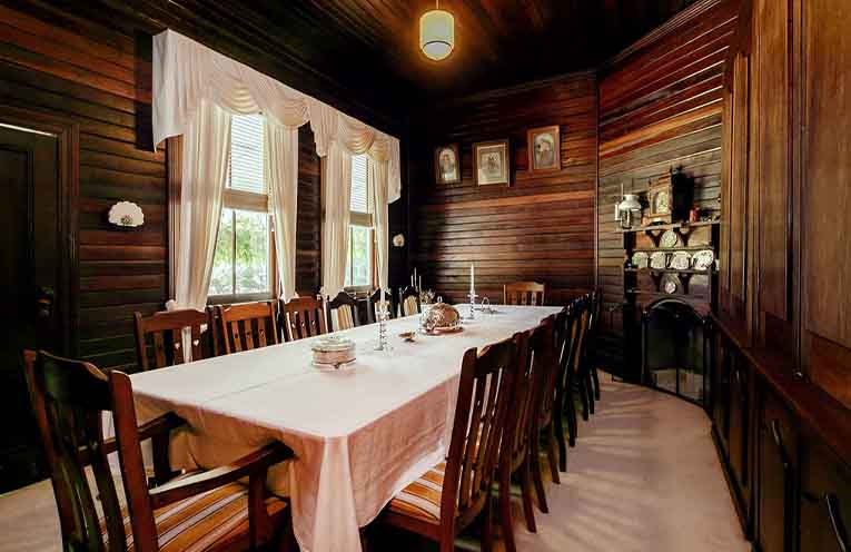 The dining room with original timber walls and historic character.