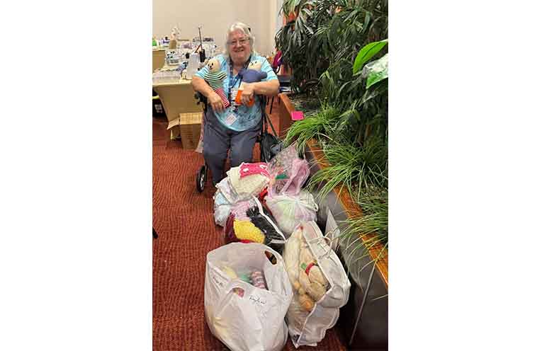 Doreen Burns, President of CWA Wauchope accepting items from the Hospital Support Committee.