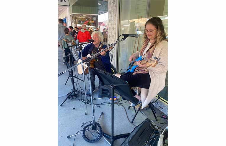 The U3A ukulele band strumming tunes.