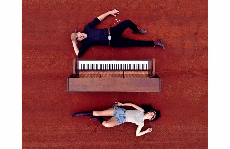 Grace Hickey and Hugh Scott Murray with their well-travelled upright piano. Photo: Supplied.