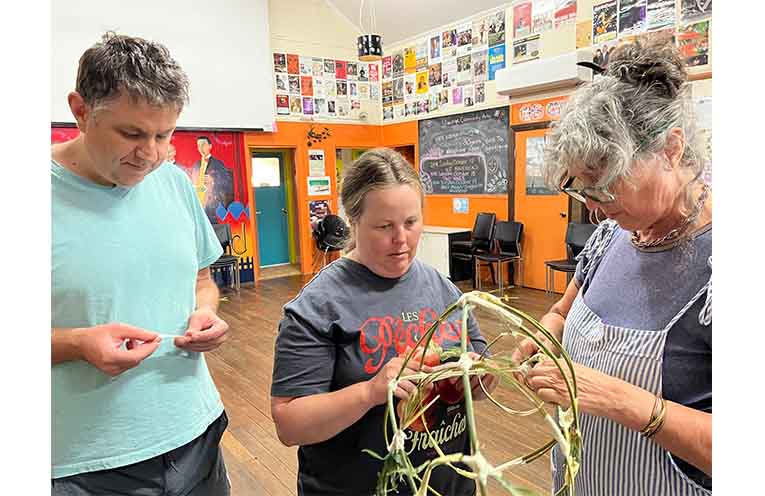 Chris Wood (left), Kerri Cains and Jo Davidson work on a prop for a WRAP performance. Photo: Supplied.
