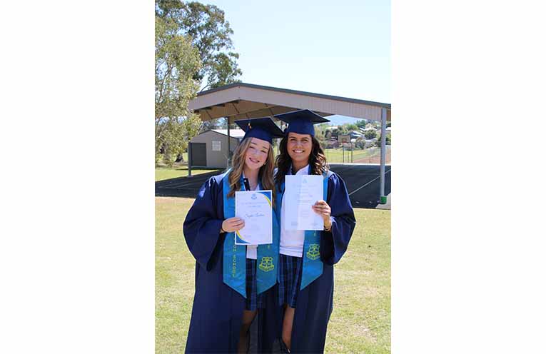 Sophie Lenehan (left) and Georgia Ellis celebrate their graduation after placing first and second, respectively, in Year 12 at Gloucester High School. Photo: Supplied.